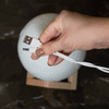 Demonstrating how to charge the Mind-glowing Moon Night Light